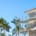 a house under construction with scaffolding and palm trees
